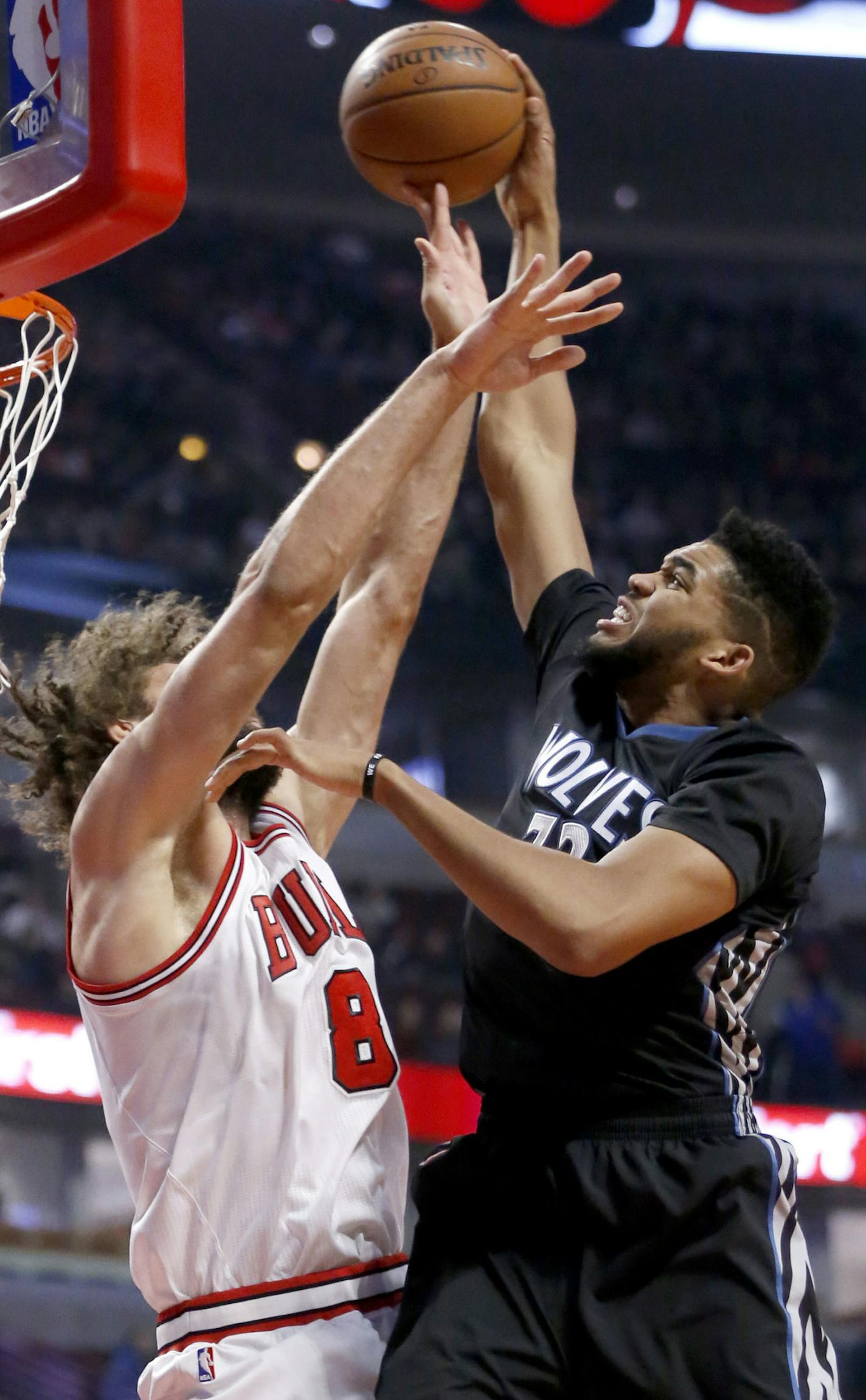 Minnesota Timberwolves' Karl-Anthony Towns, right, shoots against Chicago Bulls' Robin Lopez during the first half of an NBA basketball game Tuesday, Dec. 13, 2016, in Chicago. (AP Photo/Charles Rex Arbogast)