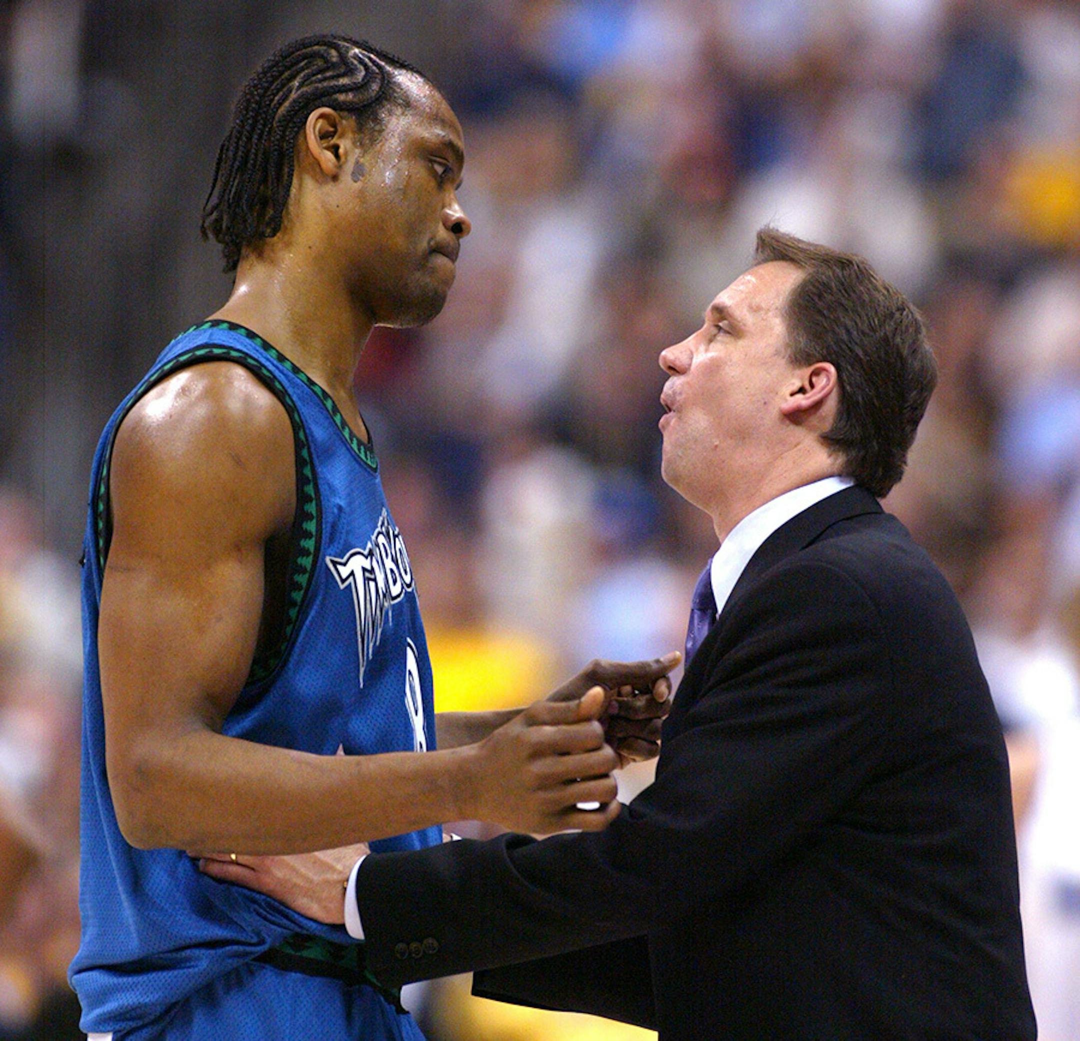 Head coach Flip Saunders confers with Latrell Sprewell on the sidelines in the second quarter of an April 24, 2004, game against the Denver Nuggets. The Timberwolves squeaked past the Nuggets 84-82 to take Game 4 of their playoff series at Pepsi Center in Denver.