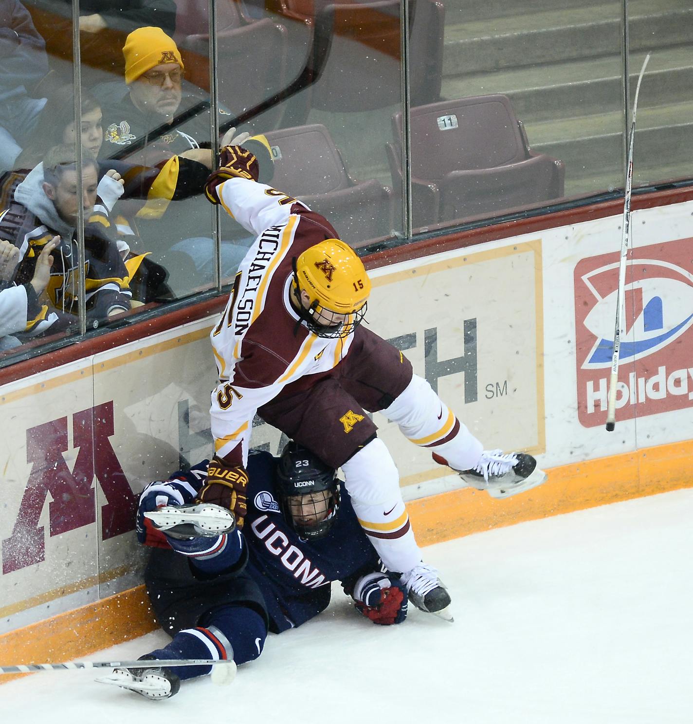 Sticks flew during a collision between Minnesota Golden Gophers left wing A.J. Michaelson (15) and Connecticut Huskies forward Kasperi Ojantakanen (23) in the first period. ] (AARON LAVINSKY/STAR TRIBUNE) aaron.lavinsky@startribune.com The University of Minnesota Golden Gophers men's hockey team played the Connecticut Huskies on Friday, Jan. 1, 2015 at Mariucci Arena in Minneapolis, Minn.