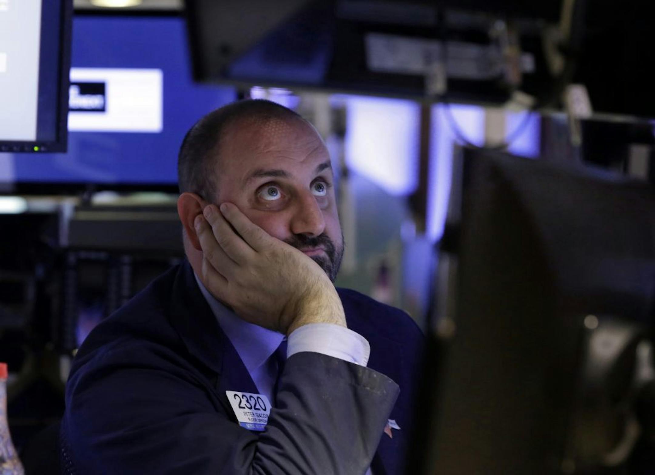 Specialist Peter Giacchi watches his screens as he works on the floor of the New York Stock Exchange, Monday, June 24, 2013. Traders in the U.S. dumped stocks, bonds and commodities, prompted by signs of distress in China's economy and worries about the end of the Federal Reserve bank's easy money policies.