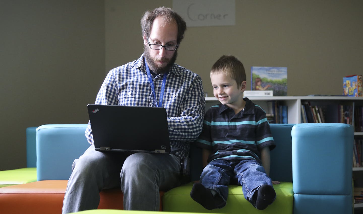 Teacher Jeff Booker worked with 7-year-old Landon Ludwig on Wednesday in the media room at Karner Blue school in Blaine.