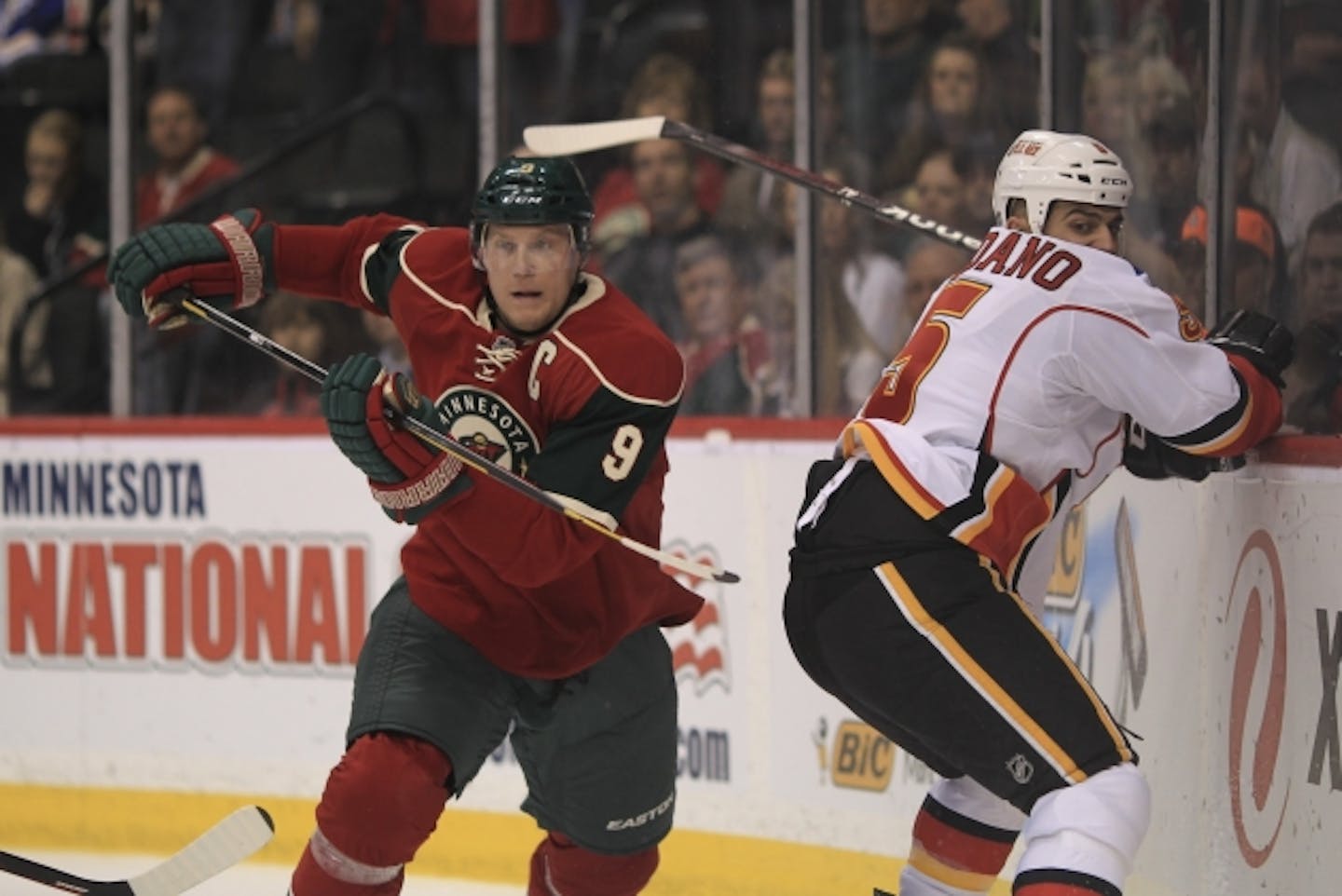 The Minnesota Wild faced the Calgary Flames in an NHL hockey game Thursday night, March 22, 2012 at Xcel Energy Center in St. Paul, Minn. The Wild's Mikko Koivu and the Flames' Mark Giordano took off after the puck after chasing it behind the Calgary net in the first period. ] JEFF WHEELER • jeff.wheeler@startribune.com