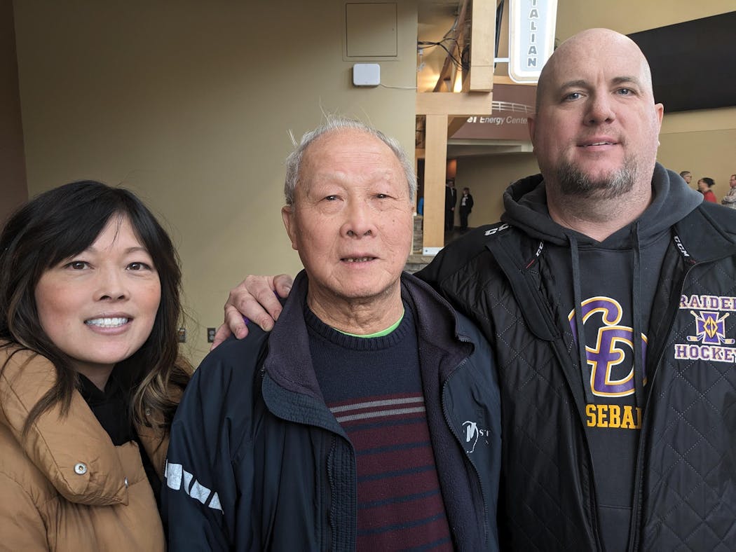 Cretin-Derham Hall goalie Owen Nelson's family (from left): Mother Hong, grandfather Chan Ly and father Mike Nelson. Owen's mask pays tribute to his family and teammate.