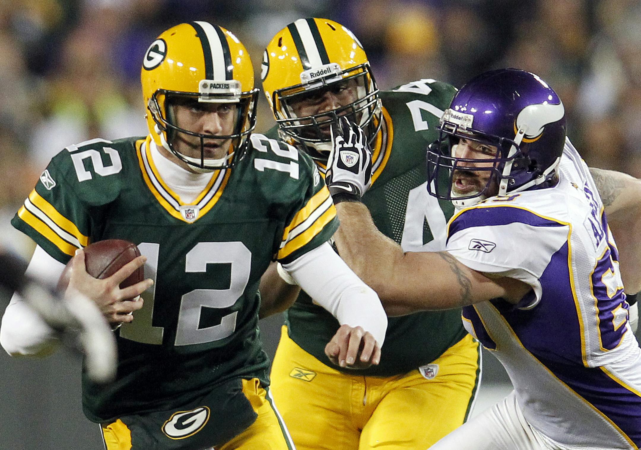 Aaron Rodgers (12) scrambled away from Jared Allen (69) in the second quarter. ] CARLOS GONZALEZ cgonzalez@startribune.com, November 14, 2011, Green Bay, WI, NFL, Lambeau Field, Minnesota Vikings vs. Green bay Packers ORG XMIT: MIN2012091411434555