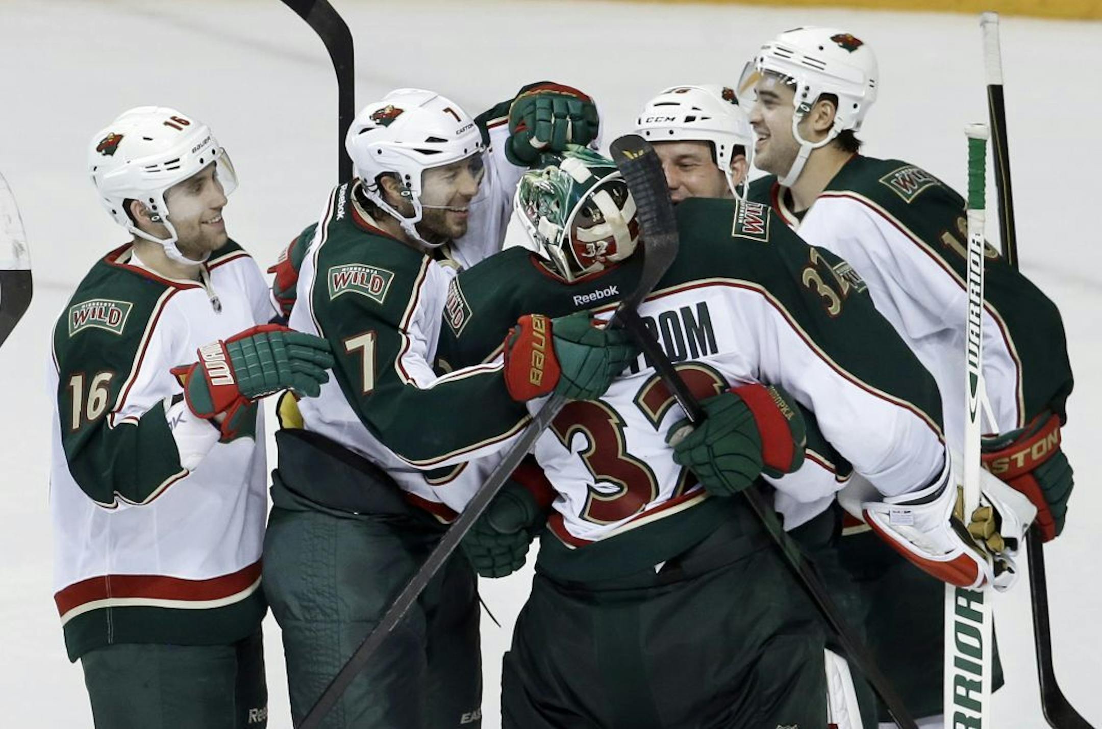 Minnesota Wild goalie Niklas Backstrom (32), of Finland, is congratulated by Jason Zucker (16), Matt Cullen (7), Zenon Konopka, second from right, and Devin Setoguchi (10) after the Wild beat the Nashville Predators 2-1 in a shootout at an NHL hockey game on Saturday, March 9, 2013, in Nashville, Tenn.