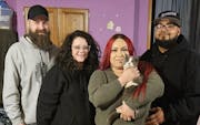 Marie Sanchez and Angel Anthony Garcia, right, pose after being reunited with Tom the "Lost Trucker Cat." Also pictured is Jeremiah Moe and Tabatha Bu
