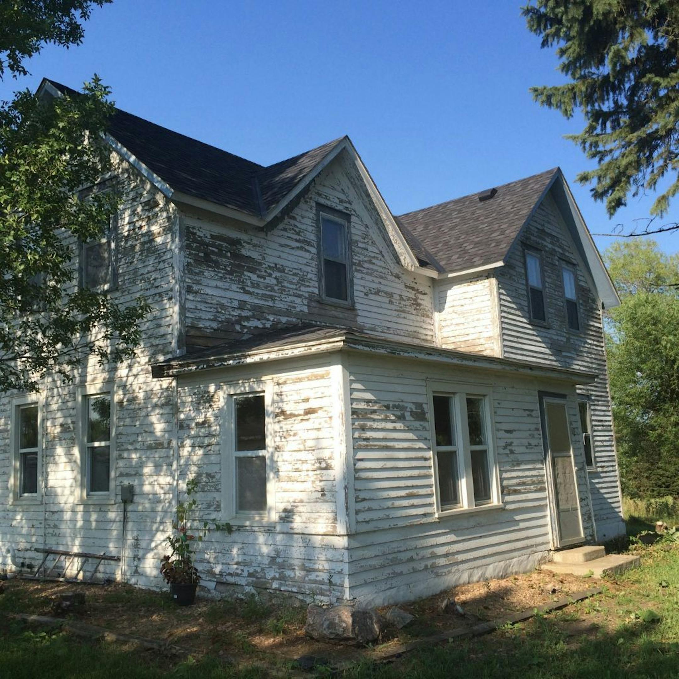 Before: The farmhouse's cedar clapboard siding badly needed repairs and paint.