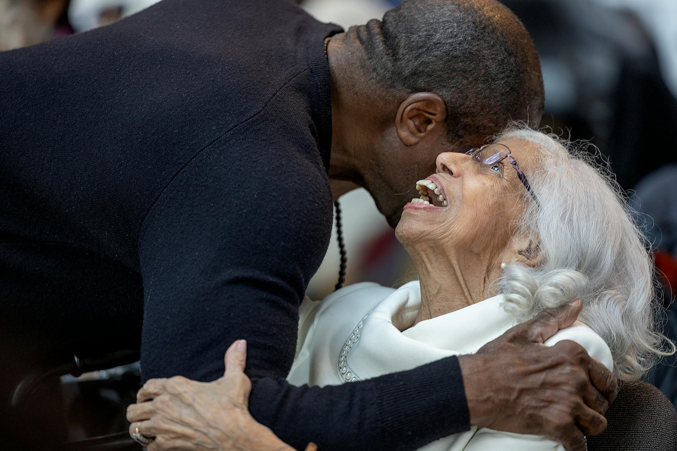 Josie R. Johnson gets one of many hugs during a ceremony honoring her.