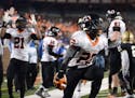 Osseo running back Prince Kruah (22) celebrated his game-tying touchdown in the final minute of his team's 6A championship game against East Ridge. ] 