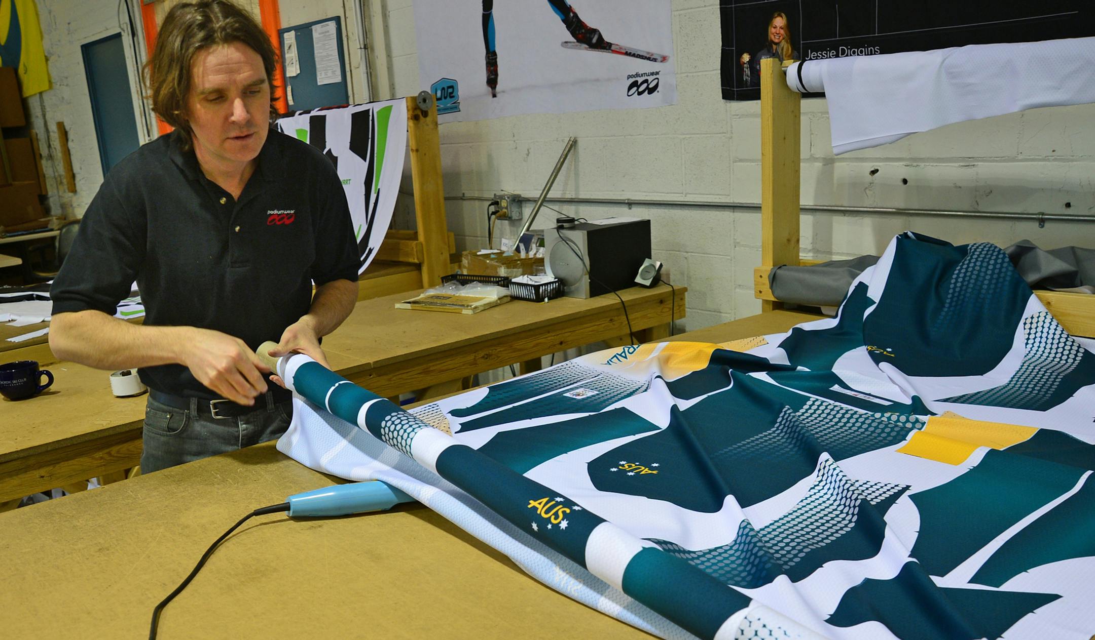Reid Lutter, owner of Podiumwear, worked on cutting out Australian olympic ski team uniforms.