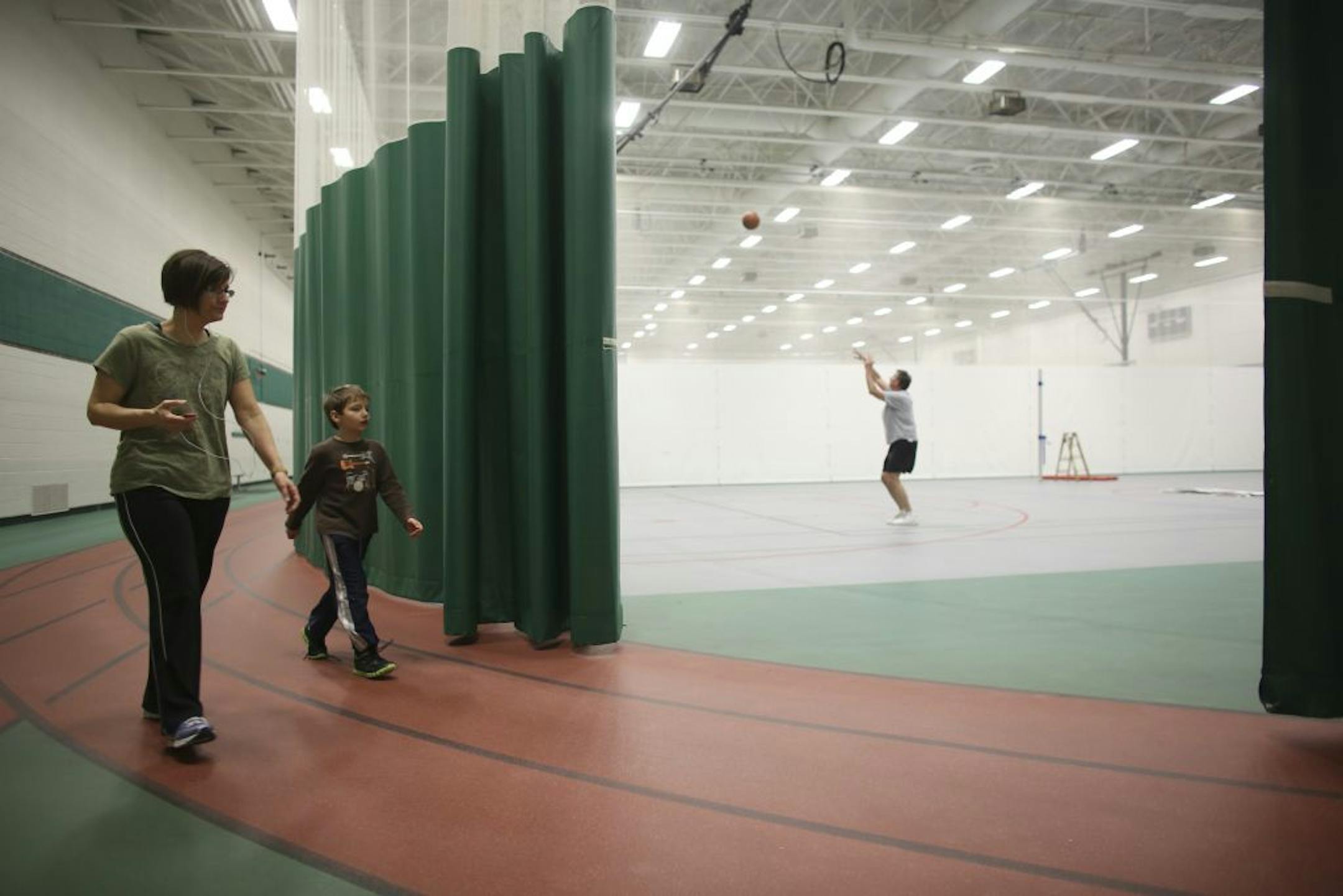 The Heart of New Ulm Project is a 10-year initiative aimed at preventing heart disease versus treating it after it occurs. The New Ulm City Recreation Center was busy on Wednesday, as it is every day, with yoga and aerobics classes and people walking on the track after work Thursday, February 7, 2013. Amy Johnson walked on the track in the Recreation Center with her son, Keenan Davis, 8, Thursday evening.