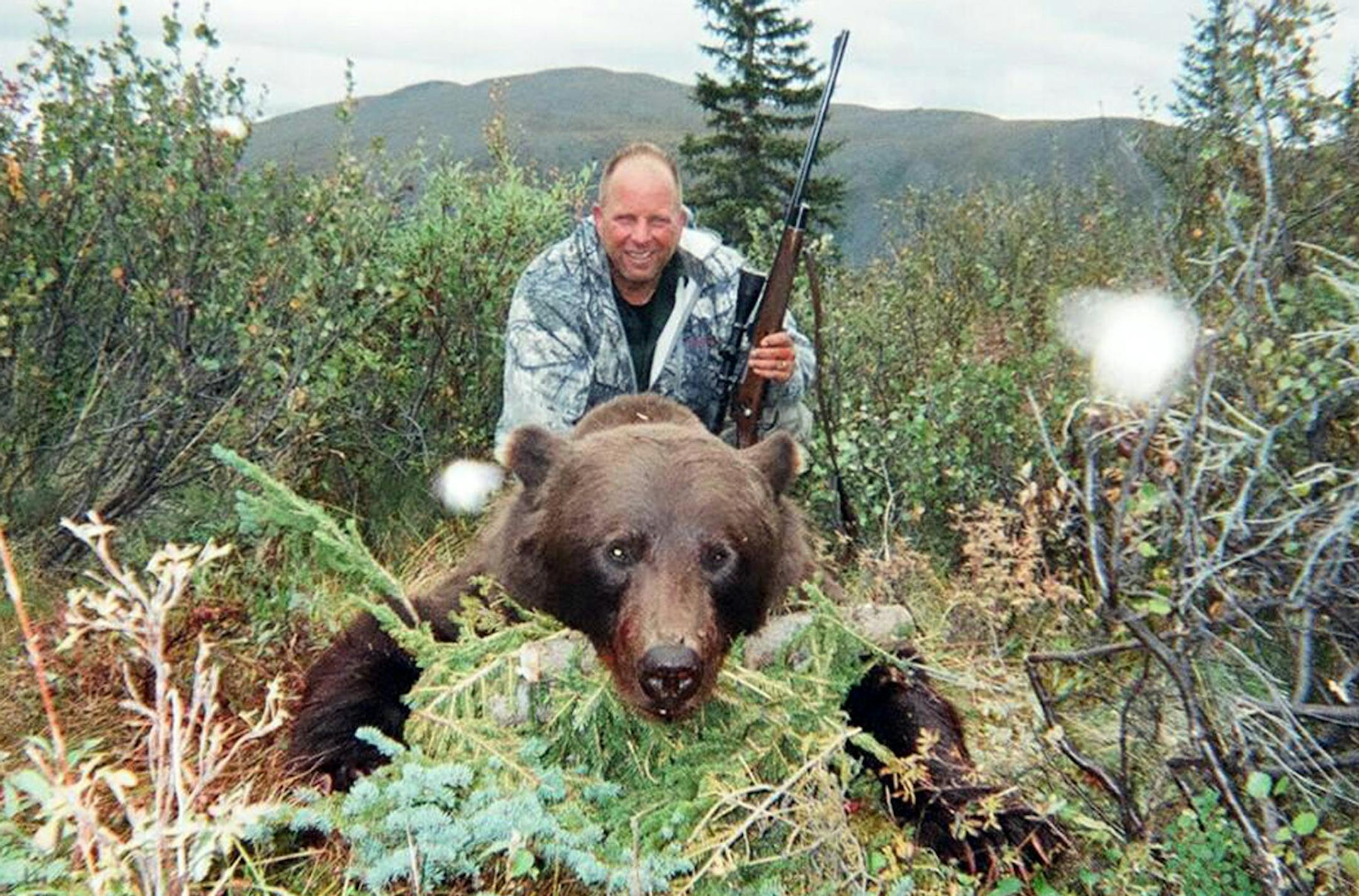 Bob Ball of Albert Lea, Minn., with the grizzly bear he shot recentlly in Alaska. The hunting trip was one of Ball's lifetime goals, and he arose each morning for two months at 3 a.m. to run and get in shape for the adventure.