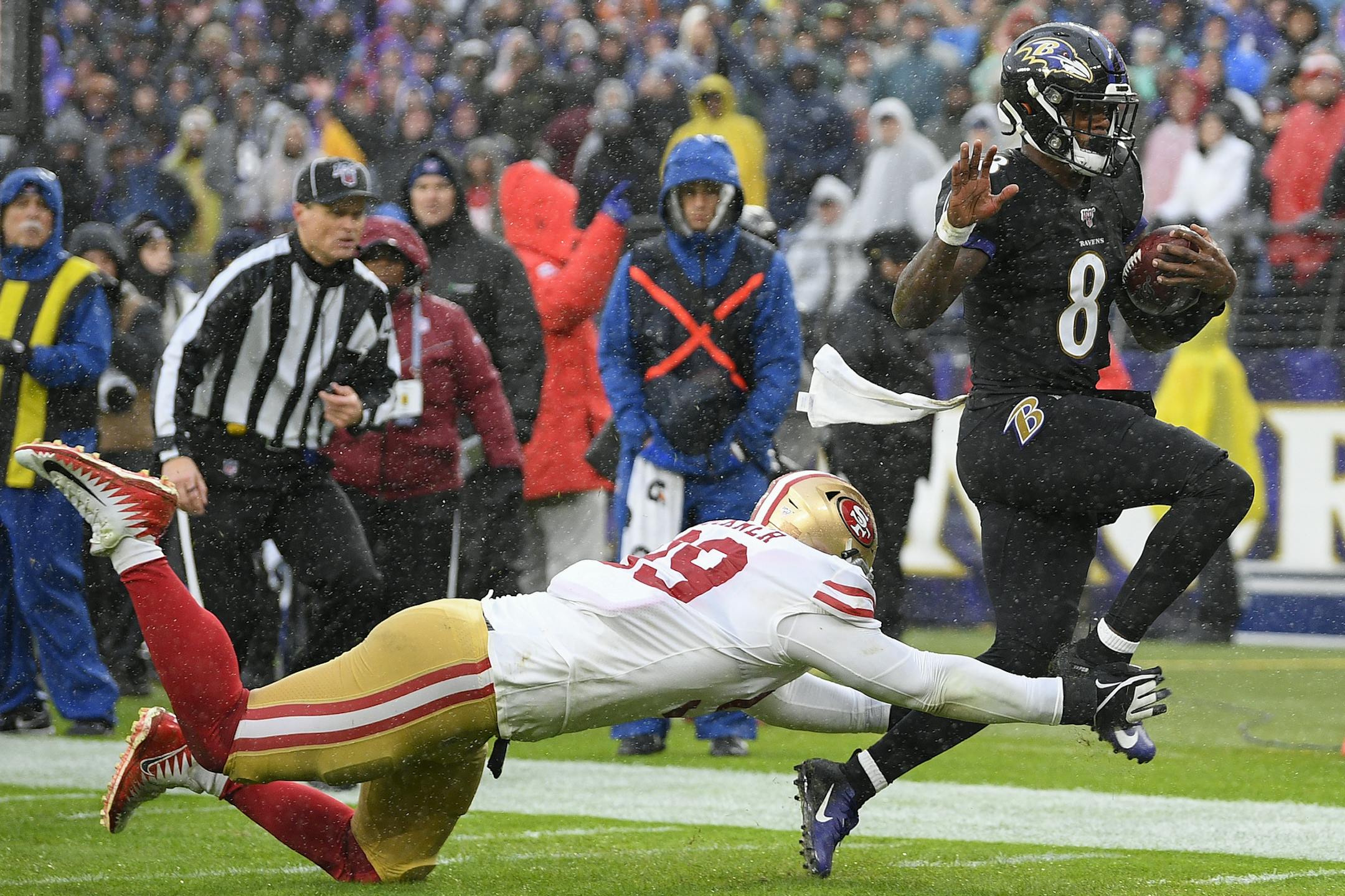 Baltimore Ravens quarterback Lamar Jackson (8) runs with the ball but is stops near the end zone by San Francisco 49ers defensive tackle DeForest Buckner (99) in the first half of an NFL football game, Sunday, Dec. 1, 2019, in Baltimore, Md. (AP Photo/Nick Wass)