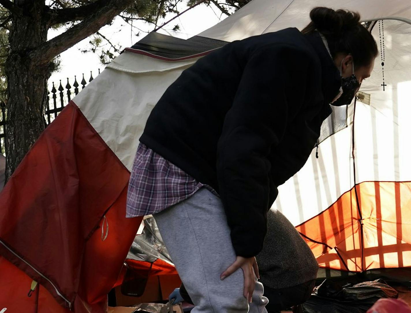 A crucifix hung from a tent where a neighbor to a homeless encampment near downtown St. Paul helped clear out the remaining tents and their contents in an encampment near Interstate 35E in September. Ramsey County commissioners are considering opening another temporary homeless shelter, this one in a vacant dorm at Luther Seminary in St. Paul's St. Anthony Park neighborhood.