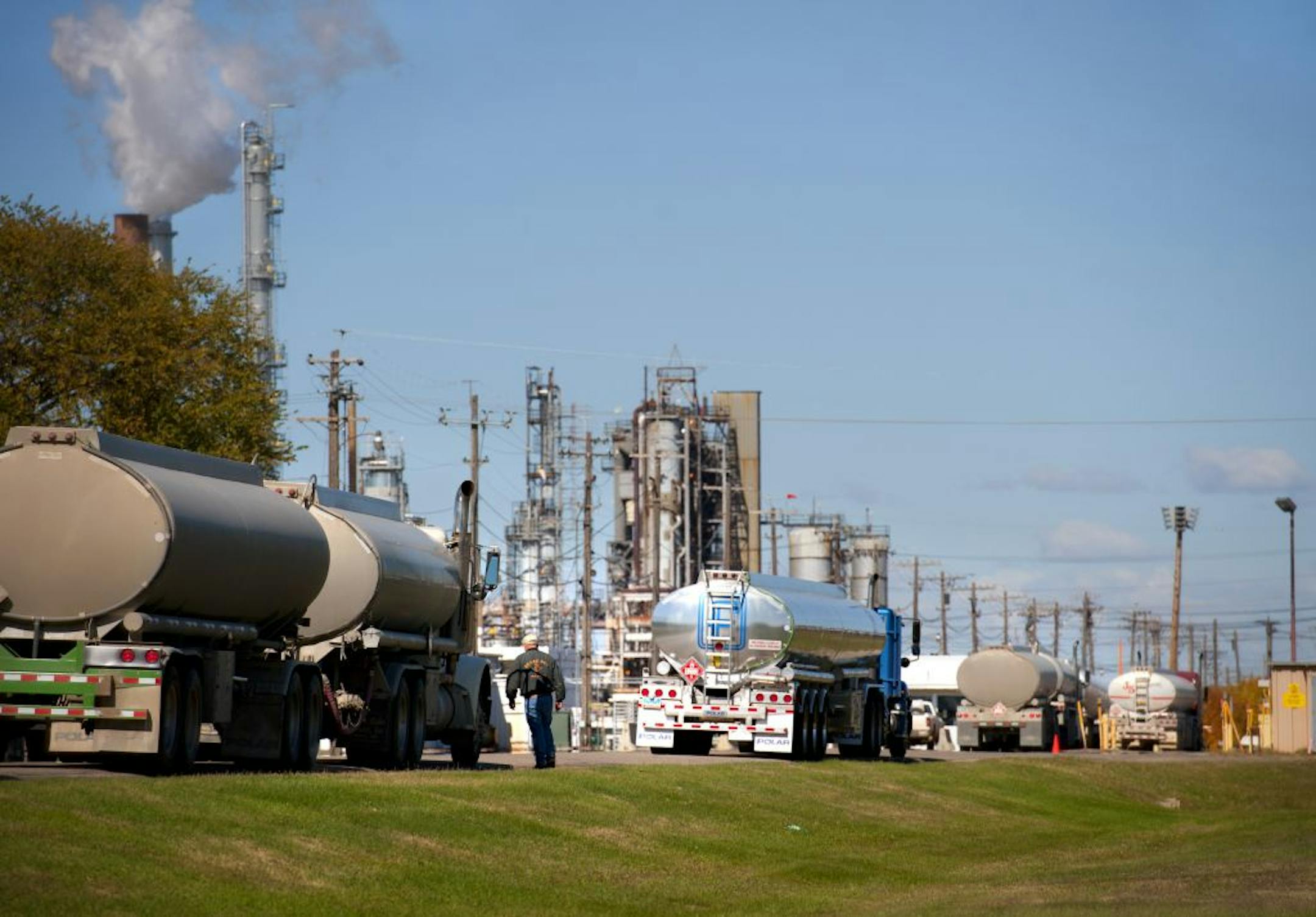 Tanker trucks lined up outisde the Tesoro Mandan refinery in Mandan, N.D. During the next 15 years, there could be 20,000 to 30,000 oil wells in North Dakota, one state executive estimated.