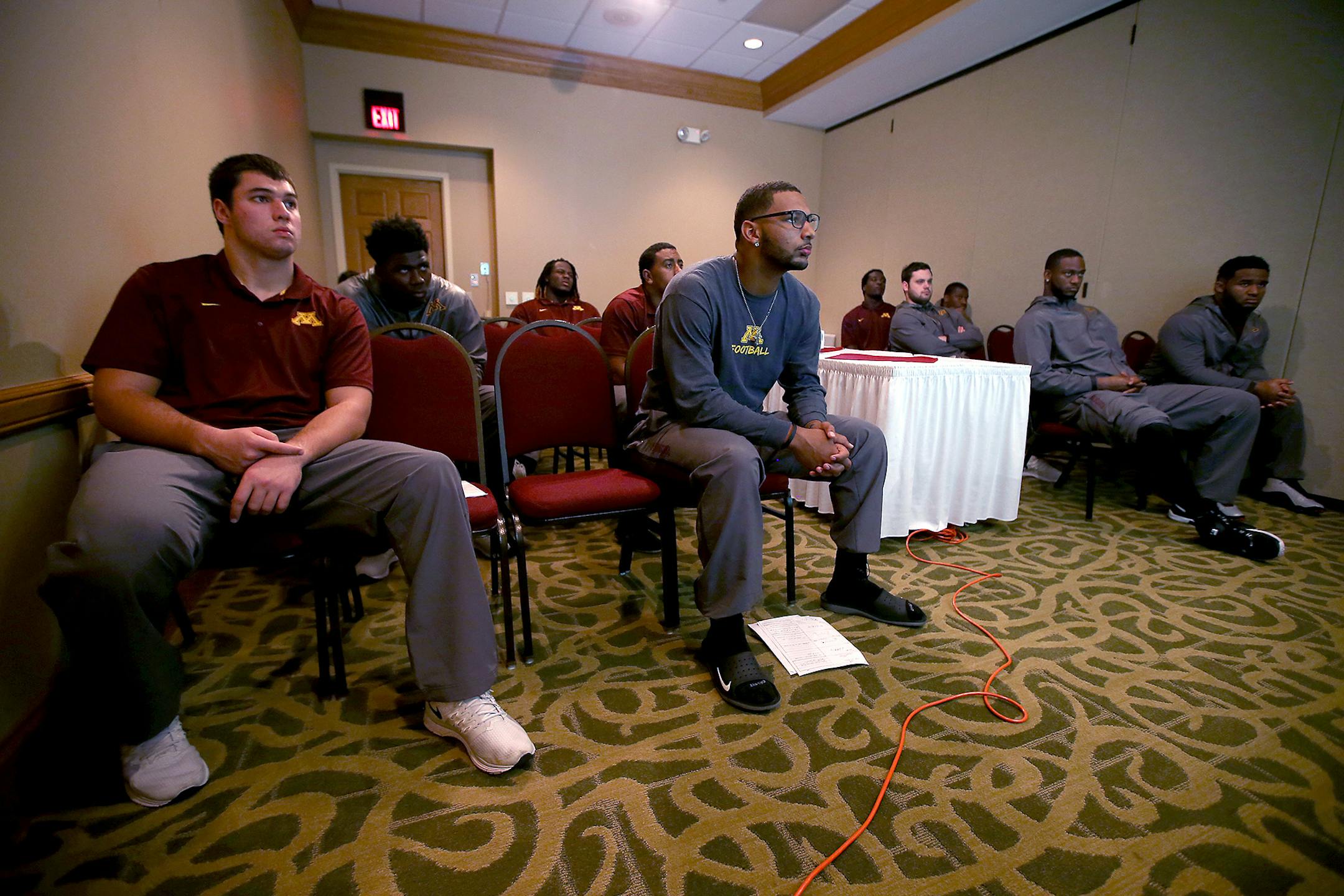 Gophers freshman Gaelin Elmore, foreground, and teammates studied the Illinois film clips assistant defensive line coach Jeff Phelps showed them during a position meeting.