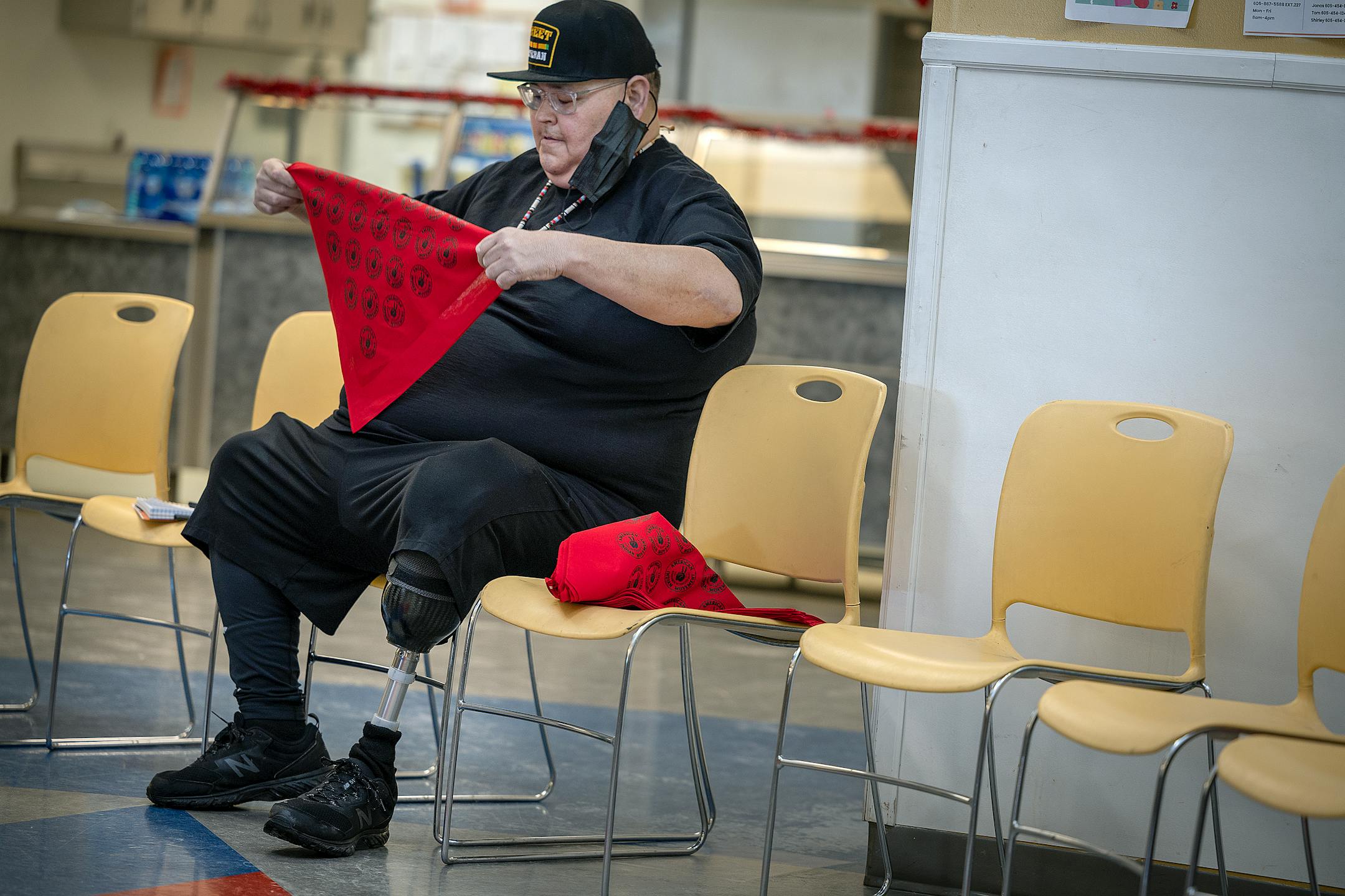 American Indian Movement member Crow Bellecourt, the son of Clyde Bellecourt, preps AIM scarfs to sell at an event honoring the Women of Wounded Knee in Porcupine, SD on the Pine Ridge Indian Reservation.