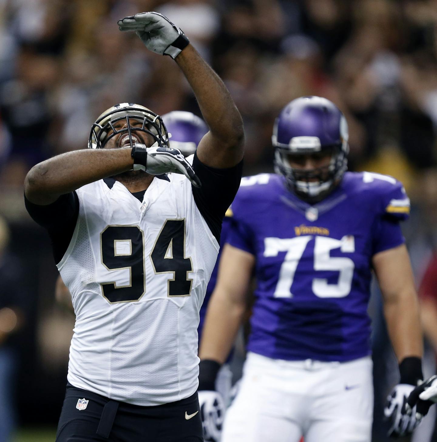 New Orleans Saints defensive end Cameron Jordan (94) celebrates a sack in the second half of an NFL football game against the Minnesota Vikings in New Orleans, Sunday, Sept. 21, 2014. Behind is Vikings tackle Matt Kalil (75). (AP Photo/Rogelio Solis)