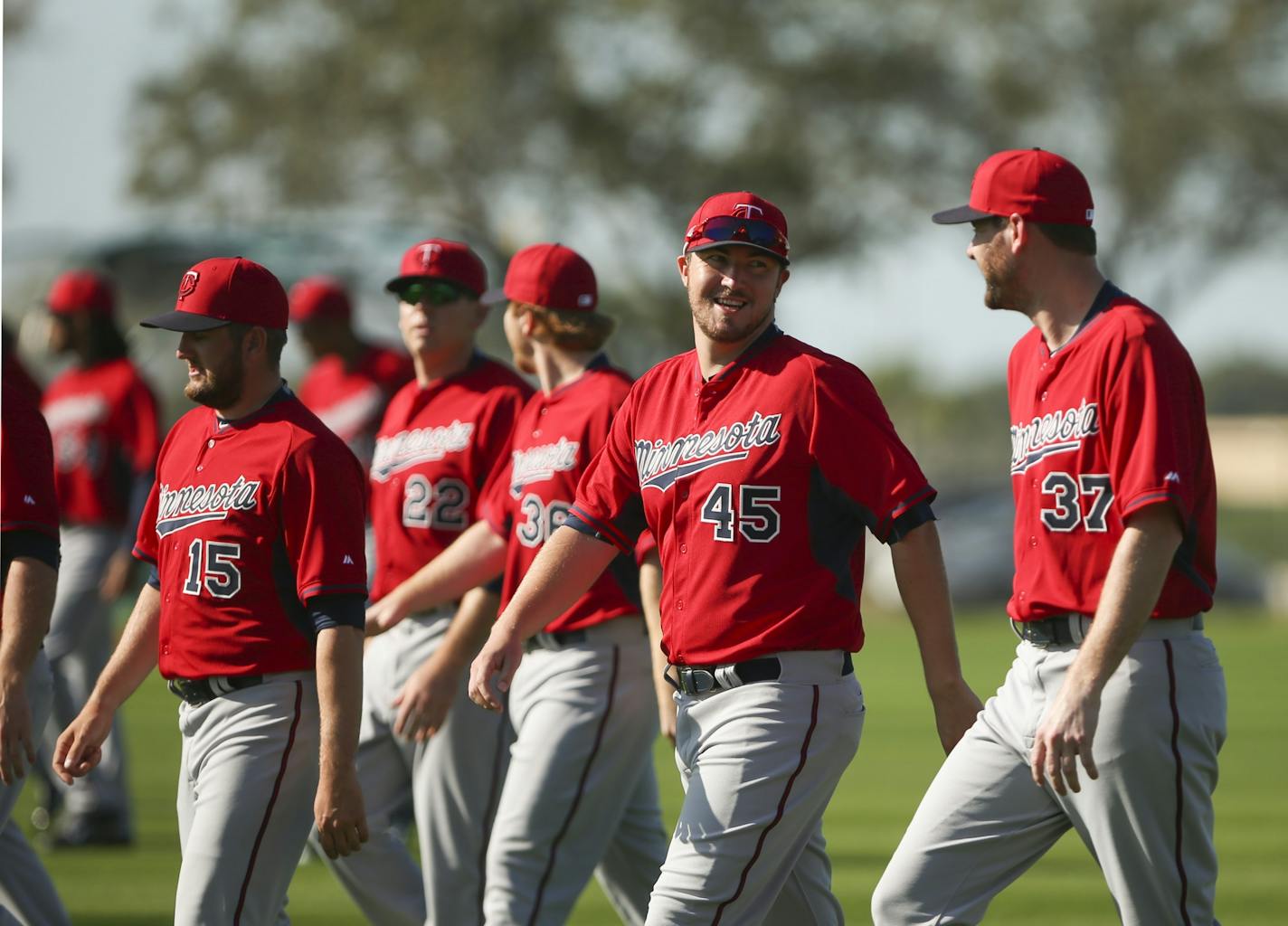 Twins pitchers, including Phil Hughes (45) walked and jogged to warm up Monday morning at Hammond Stadium.