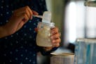 Olivia Godden prepares a bottle of baby formula for her infant son, Jaiden, Friday, May 13, 2022, at her home in San Antonio. Godden has reached out t
