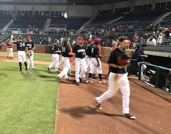 Members of the Chattanooga Lookouts celebrate their 21-inning victory Sunday. Photo courtesy of the Chattanooga Lookouts.