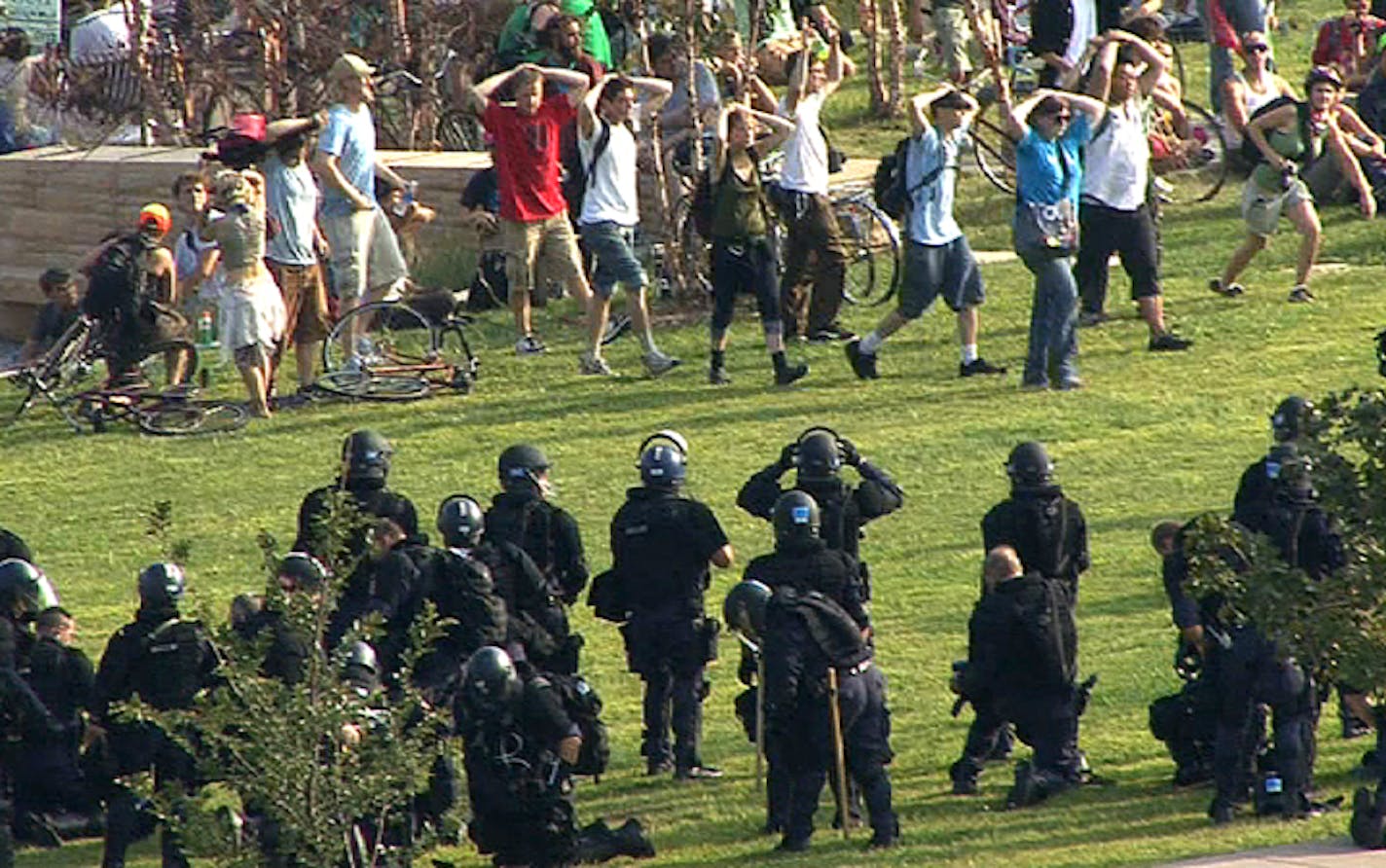 Police arrest a group of protesters along Shepard Road in St Paul.