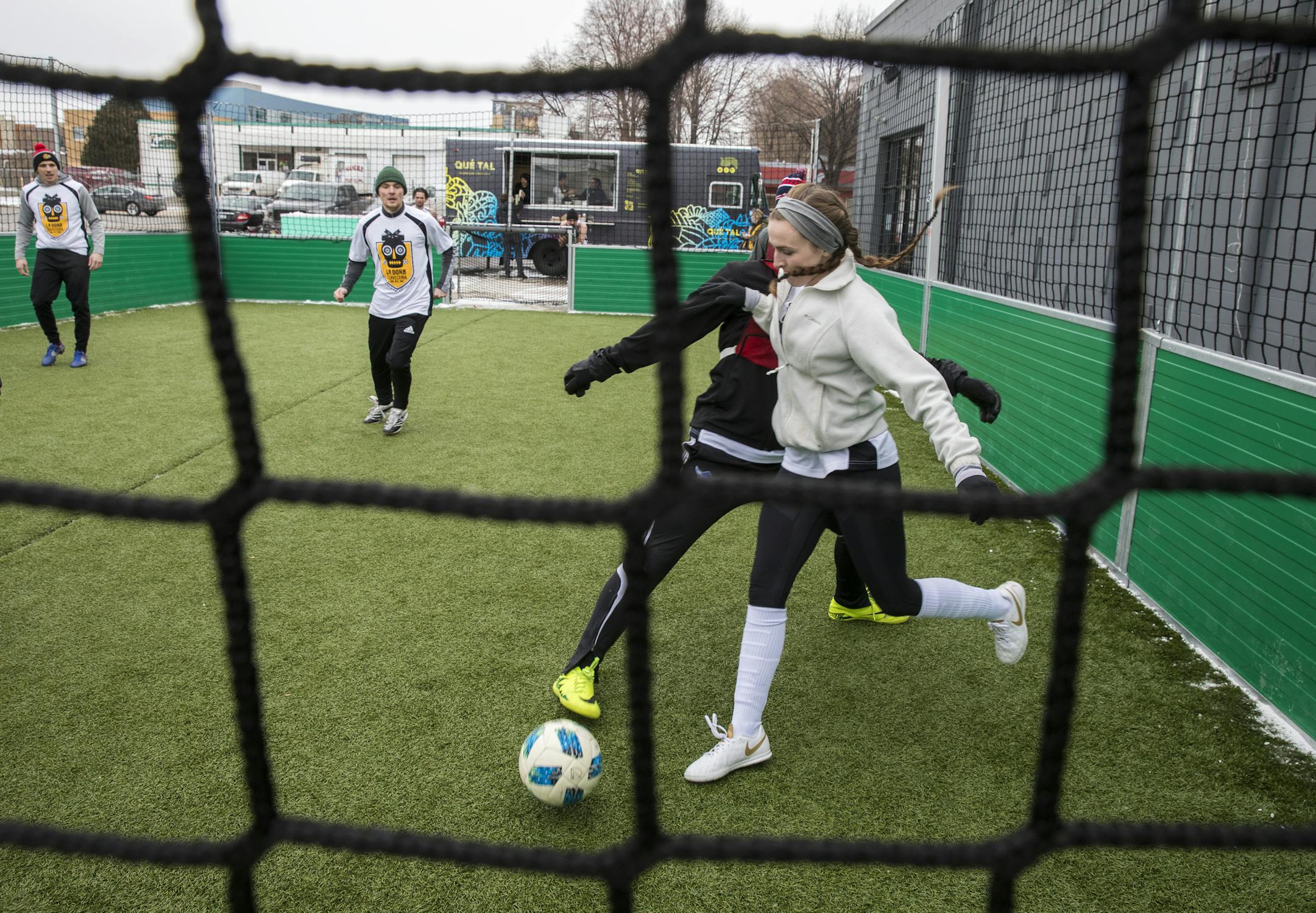Emily Segura, right, of Edina maneuvers the ball during a 3-on-3 soccer game while competing in La Do–a Cervecer’a's Fœtbol and Social Club in the Harrison neighborhood of north Minneapolis on Saturday, Nov. 10, 2018. (Liam James Doyle for the Star Tribune) ORG XMIT: MIN1811112228005335