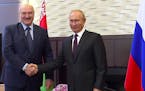 In this photo taken from video and released by Russian Presidential Press Service, Russian President Vladimir Putin, right, and Belarusian President A