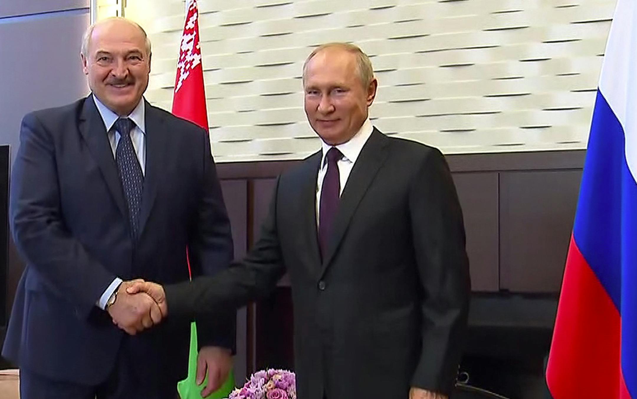 In this photo taken from video and released by Russian Presidential Press Service, Russian President Vladimir Putin, right, and Belarusian President Alexander Lukashenko shake hands during their meeting in the Bocharov Ruchei residence in the Black Sea resort of Sochi, Russia, Monday, Sept. 14, 2020. Belarus' authoritarian president is visiting Russia in a bid to secure more loans and political support as demonstrations against the extension of his 26-year rule enter their sixth week. Alexander