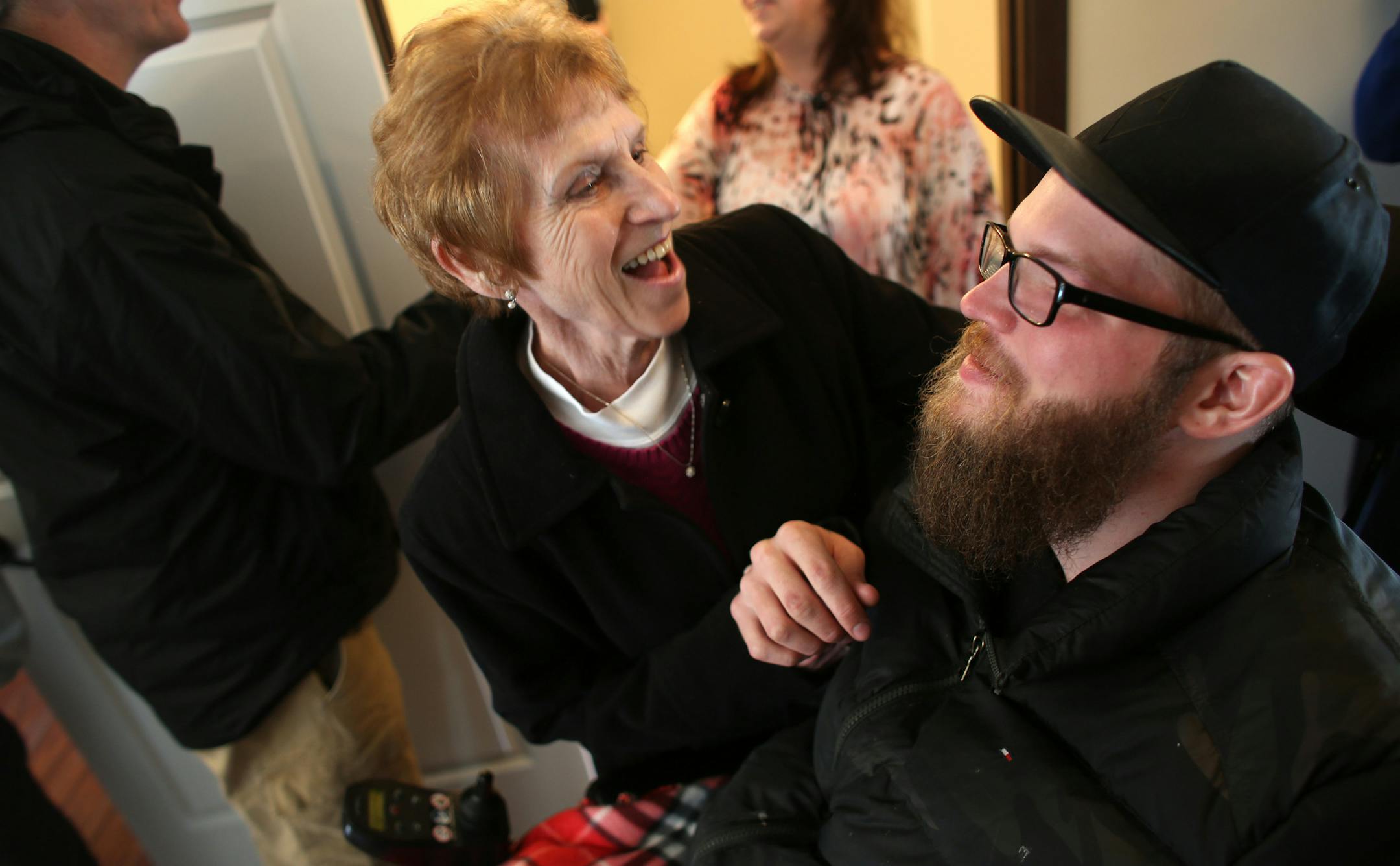 Zach Mohs smiled with family member Pat Rossmeisl as he toured the new home made to fit his needs after he was injured in an accident.