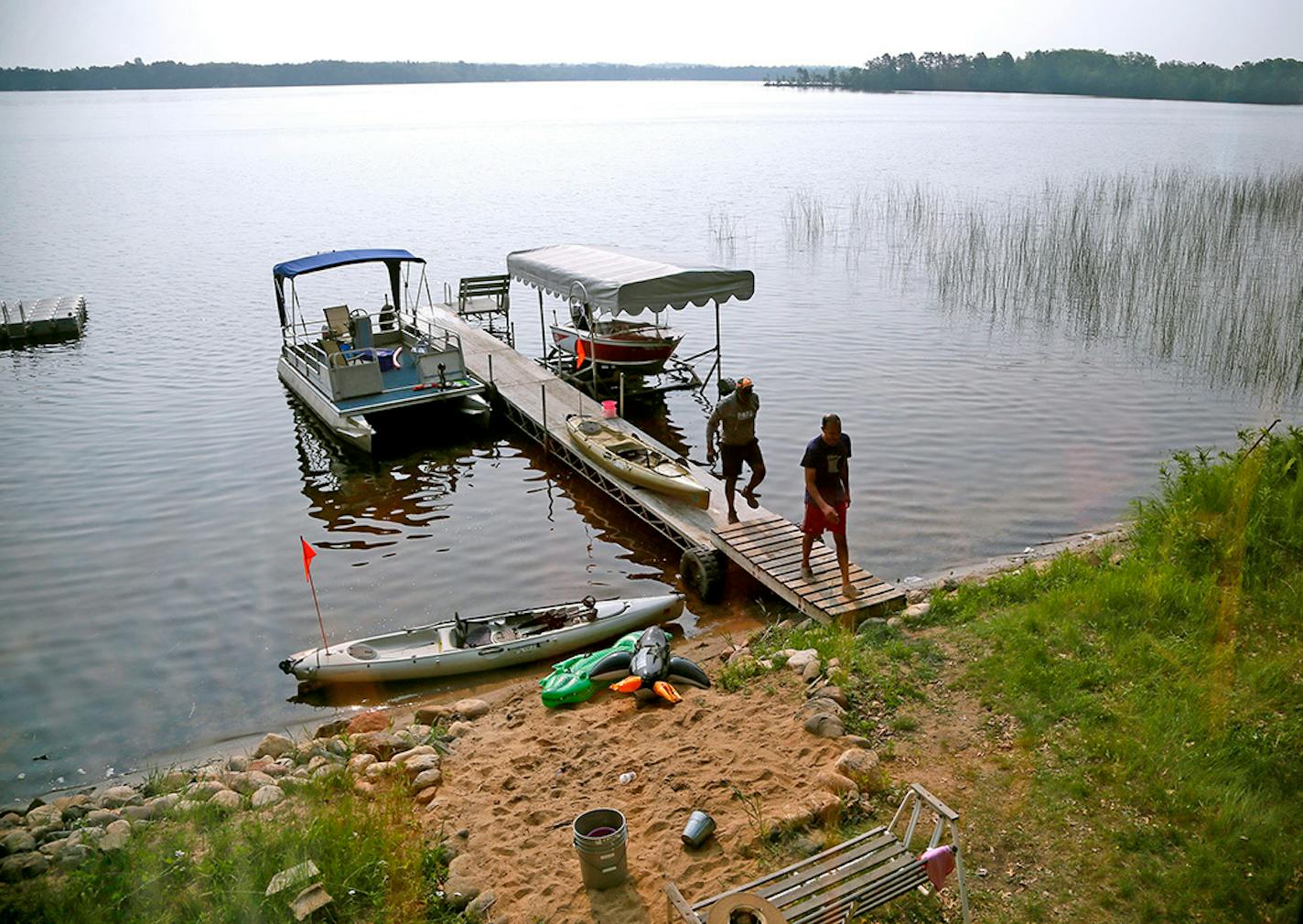 Justice Alan Page left and his son Justin Page walked up to there cabin on Independence Day on Washburn Lake Saturday July 4, 2015 in Outing, MN.