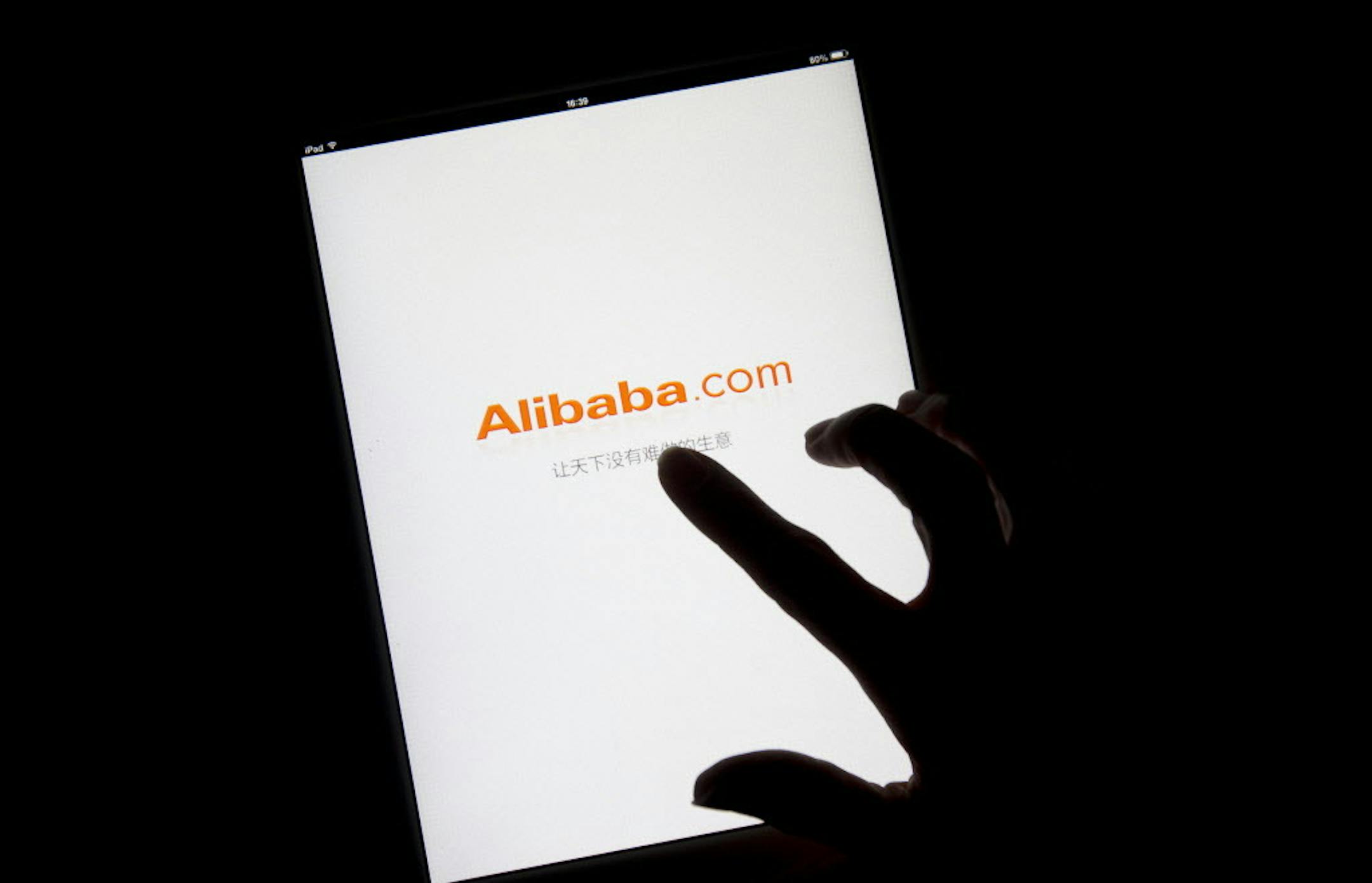 FILE PHOTO: The Alibaba Group Holding Ltd. logo is displayed on an app loading page on an Apple Inc. iPad in this arranged photograph in Hong Kong, China, on Sunday, April 20, 2014. Alibaba, which rode China's emergence as an economic superpower over the last 15 years to become a massive online marketplace for everything from forks to forklifts, filed today for what could become the largest U.S. initial public offering ever. Photographer: Brent Lewin/Bloomberg ORG XMIT: 488897207