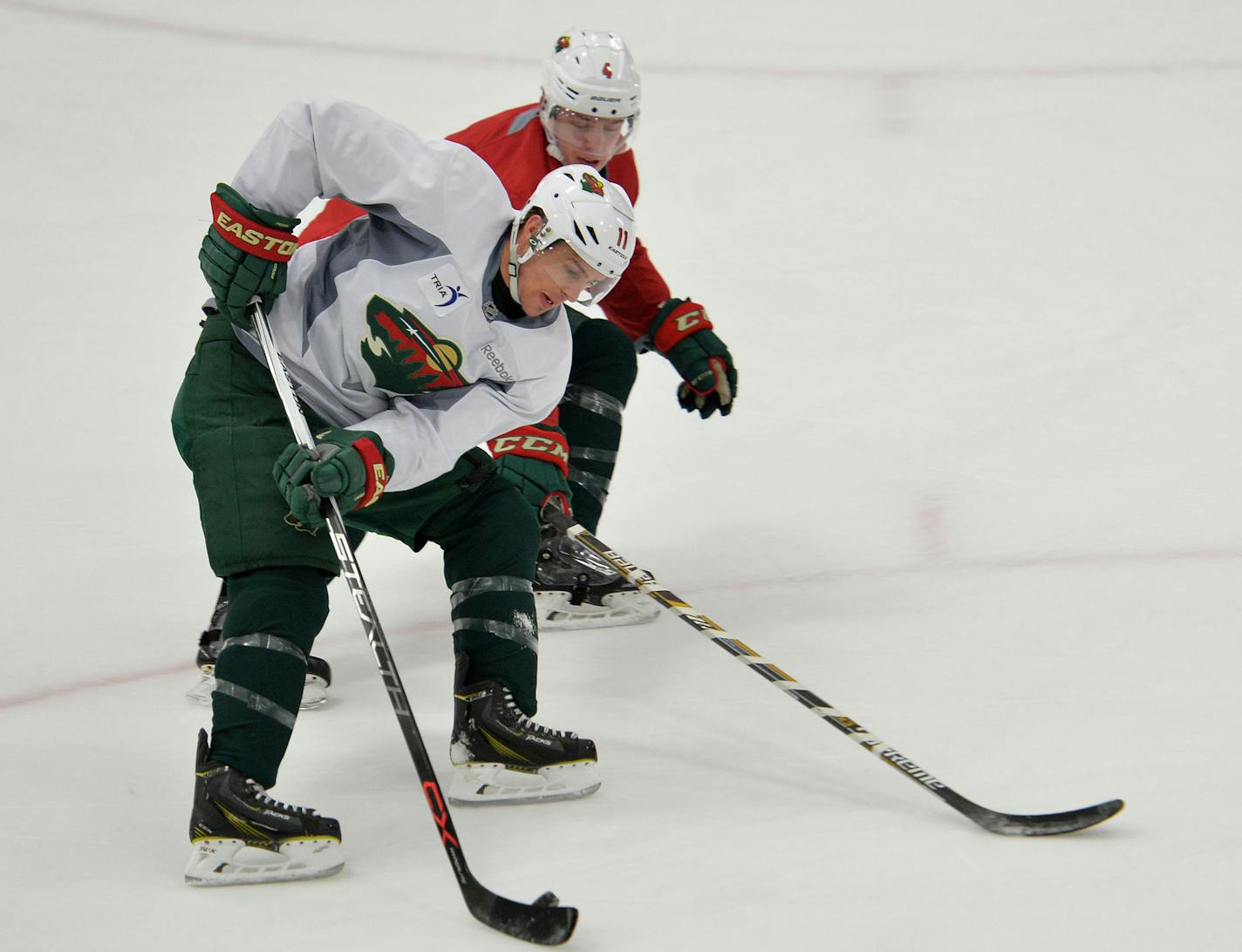 Minnesota Wild left wing Zach Parise battles defender Mike Reilly during a practice drill Sunday, February 14 at Braemer Arena in Edina, the morning after Wild Head Coach Mike Yeo was fired. John Torchetti has been announced as the Wild's interim head coach. ] (SPECIAL TO THE STAR TRIBUNE/BRE McGEE) **Erik Haula (56, white), Nate Prosser (39, red), Mike Yeo (not pictured, former Minnesota Wild head coach), John Torchetti (not pictured, Minnesota Wild interim head coach)