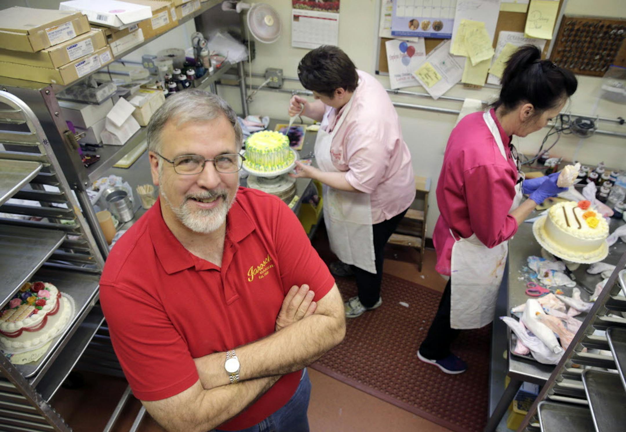 In this Friday, Oct. 24, 2014 photo, Ken Jarosch, owner of Jarosch Bakery, poses for a portrait with two skilled workers at the family bakery, in Elk Grove Village, Ill. Jarosch thinks heíll have to raise prices and hire fewer part-timers for his bakery if the stateís minimum wage rises. (AP Photo/Charles Rex Arbogast)