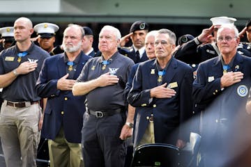 Medal of Honor recipients placed their hands over their hearts during the National Anthem. Over 30 Medal of Honor recipients gathered at U.S. Bank Sta