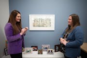 Joanna Lindell, left, and Jenna Reck talked about the etching “Ornamentation” by Minneapolis artist James Boyd Brent that Reck chose for her offic