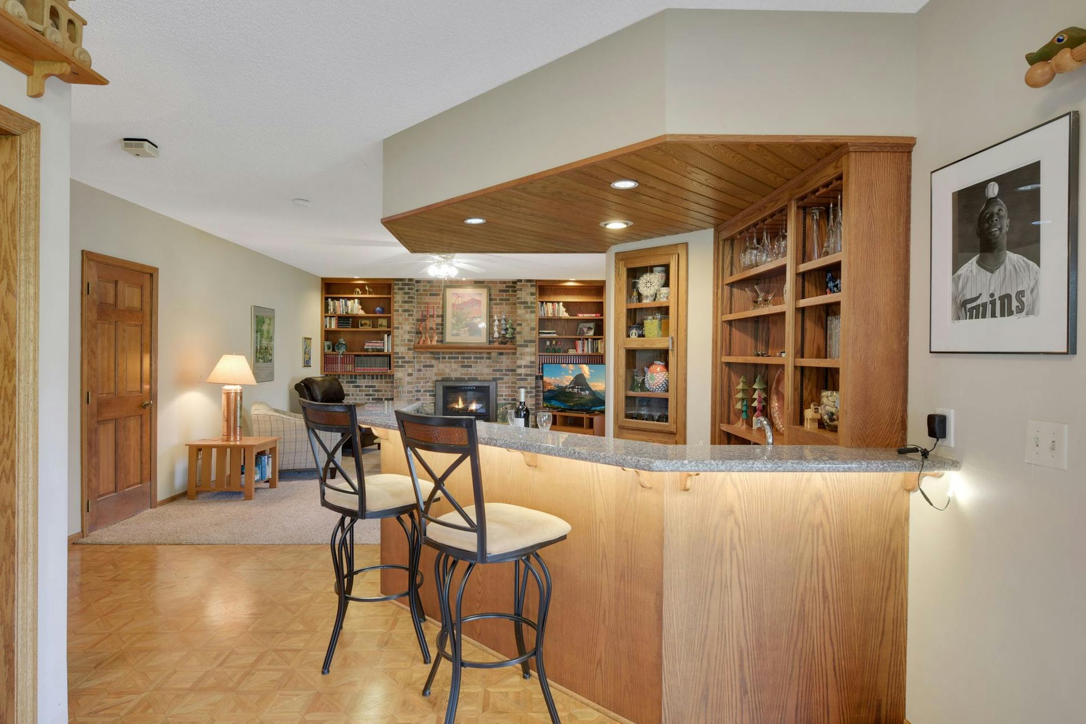 The sellers plan to include this framed photo, pictured on the wall in the wet-bar area, with only a few original copies of Kirby Puckett with the sale of the Brooklyn Park home.