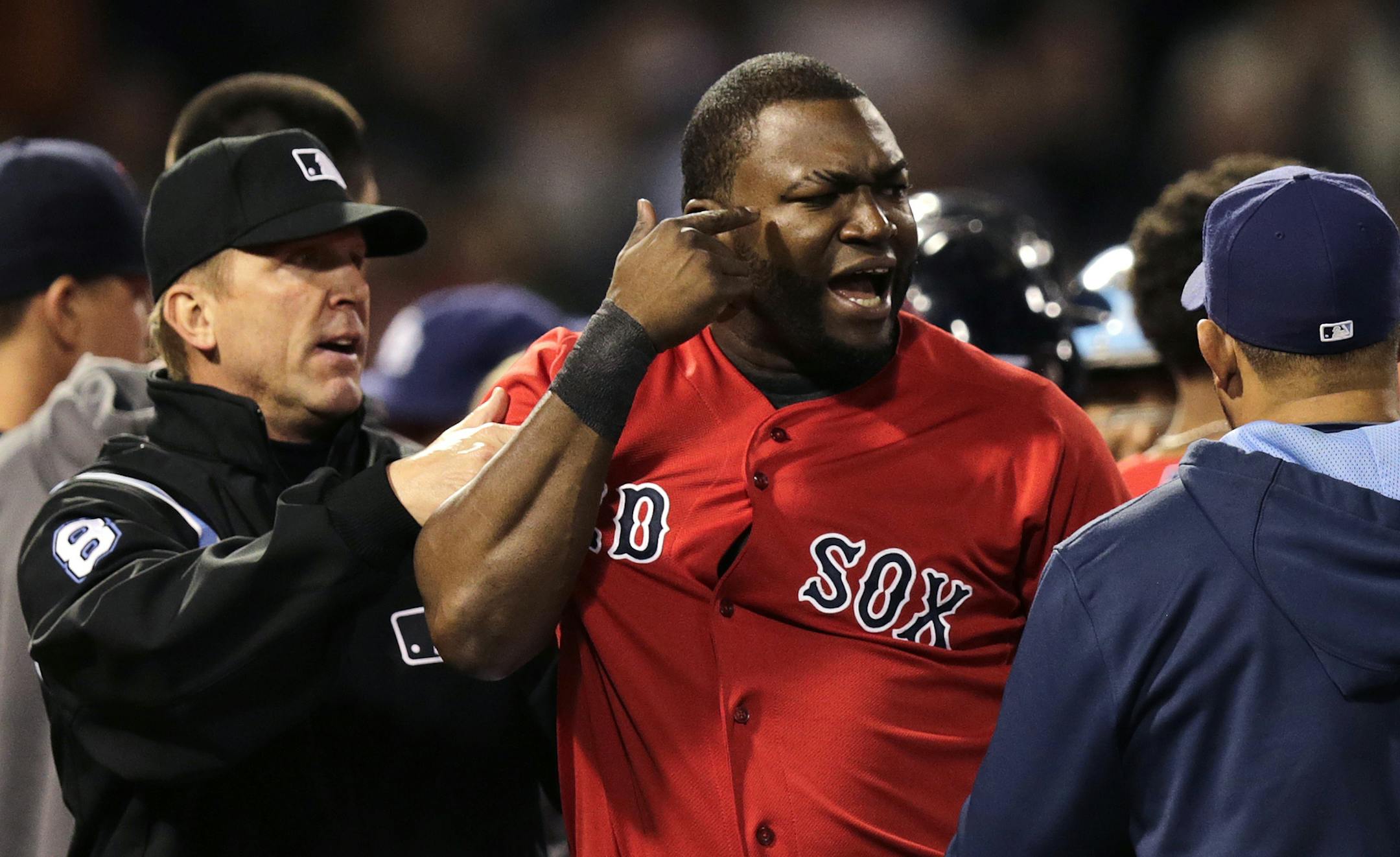 Boston Red Sox designated hitter David Ortiz is held back by umpire Jeff Kellogg after benches cleared after Tampa Bay Rays starting pitcher David Price hit Mike Carp with a pitch during the fourth inning of a baseball game at Fenway Park in Boston, Friday, May 30, 2014. (AP Photo/Charles Krupa) ORG XMIT: MIN2014061316595233