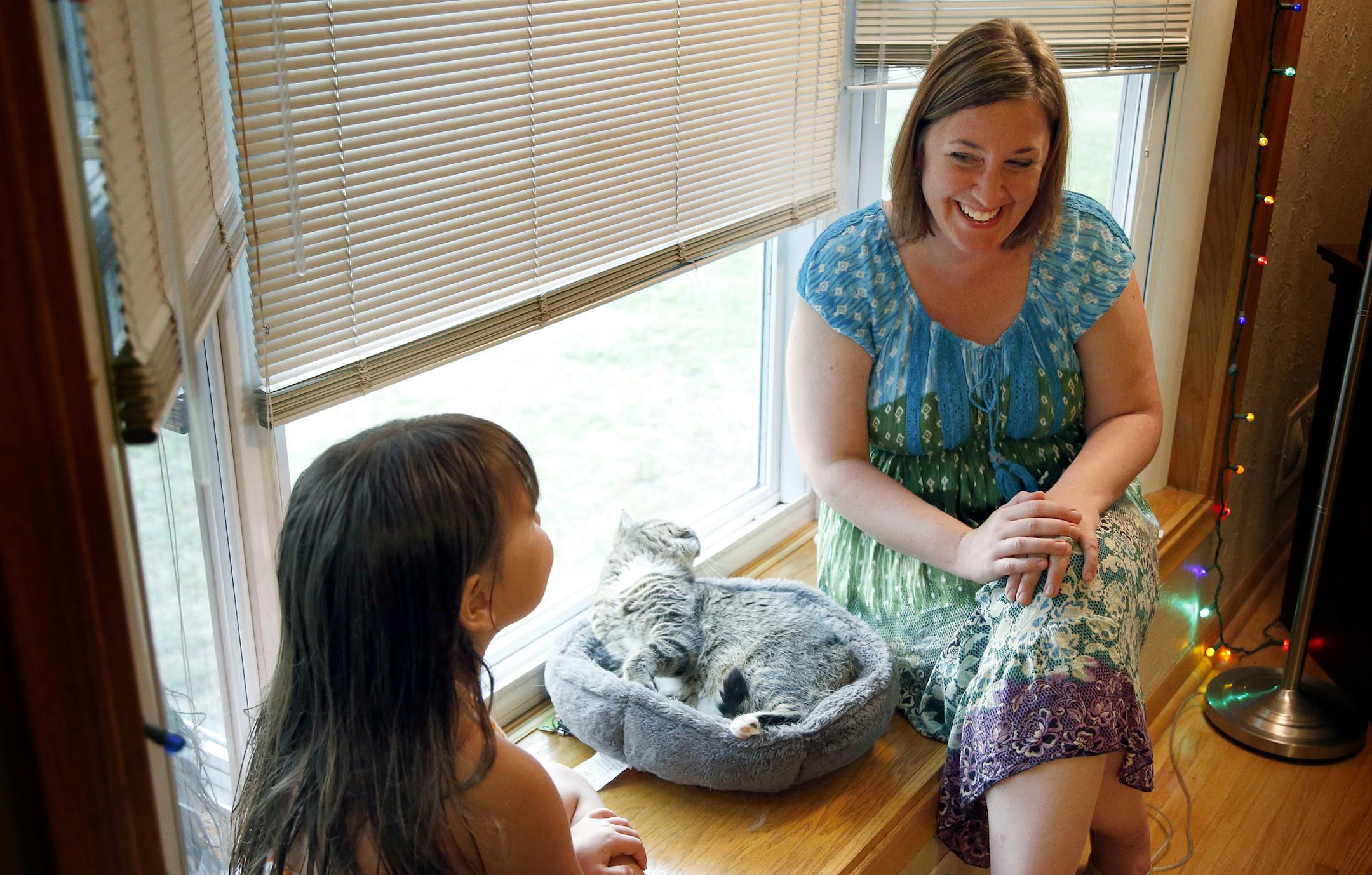 Teacher Gina Hass spoke with Makenzie Coyne, 5, at her family's home. Hass met with the Coyne family whose daughter will be attending Hass' kindergarten class. ] CARLOS GONZALEZ cgonzalez@startribune.com August 21, 2013, St. Paul, Minn., The start of the new school year was weeks away, but St. Paul teacher Gina Hass was already meeting with East Side parents, not at school, but in their homes. Hass, who begins teaching kindergarten this fall at St. Paul's American Indian Magnet School, is part o