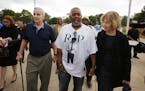 Gov. Mark Dayton and Lt. Gov. Tina Smith walk with Clarence Castile, center, the uncle of Philando Castile, at J.J. Hill Montessori School in St. Paul
