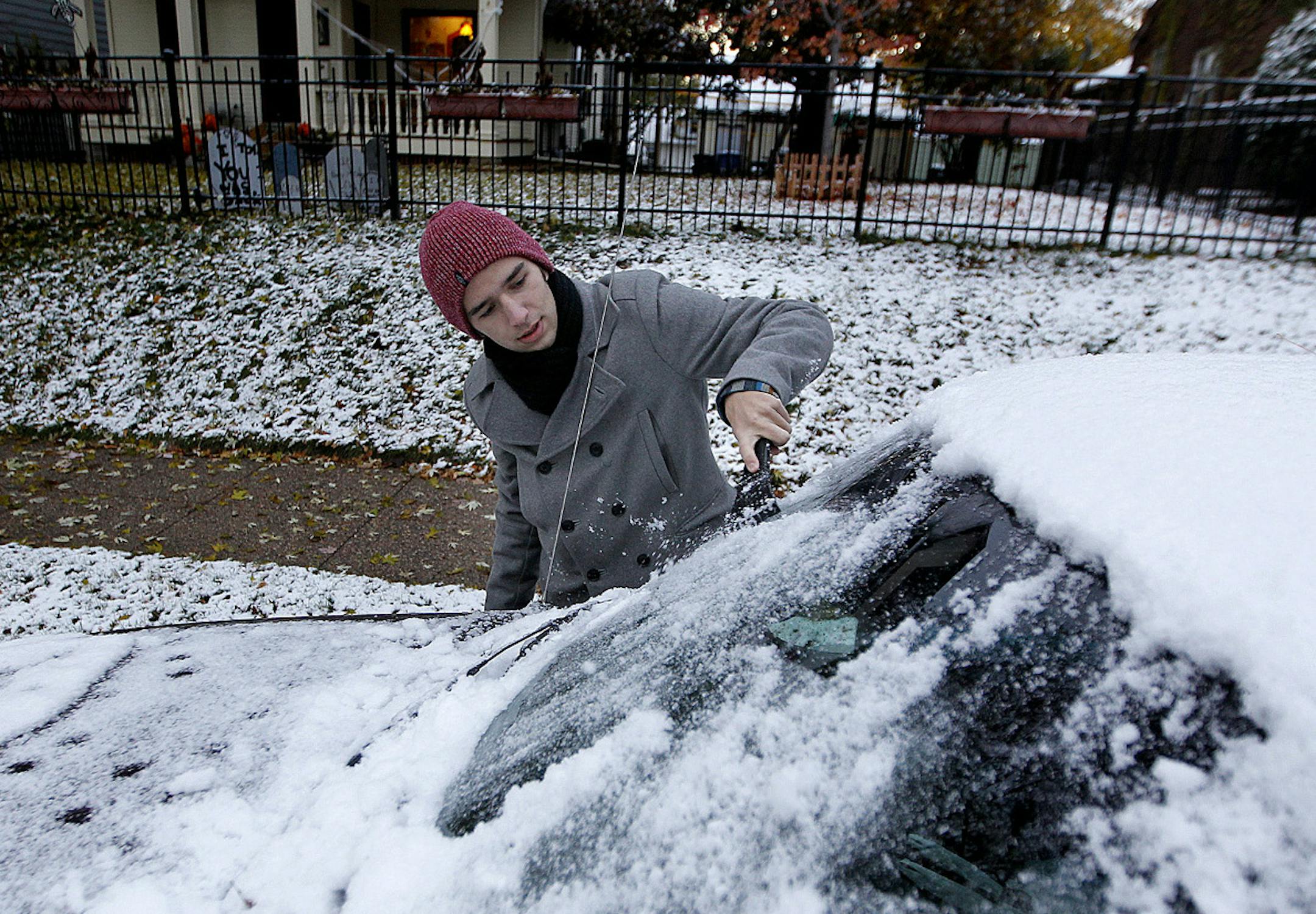 Ian Sutherland, 16, wiped off the snow that he says he was ready for from his car in route to school, Wednesday, November 6, 2013 in Minneapolis, MN. (ELIZABETH FLORES/STAR TRIBUNE) ELIZABETH FLORES &#x201a;&#xc4;&#xa2; eflores@startribune.com ORG XMIT: MIN1311060720598156