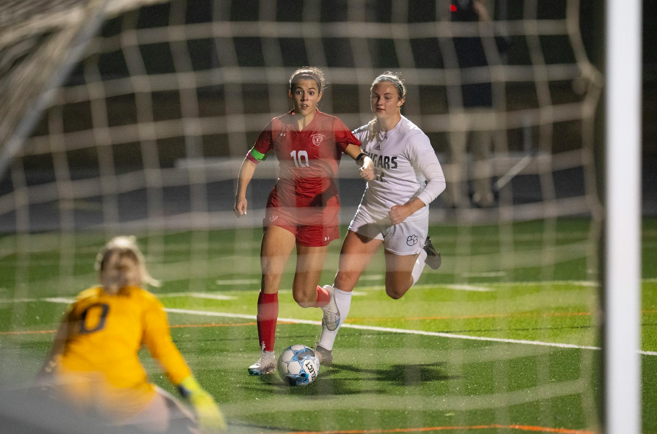 Benilde-St. Margaret's Kiya Gilliandas eyed Mankato East keeper Ashley Fischer headed for the net with Mankato East's Abigail Moule defending in the second half.