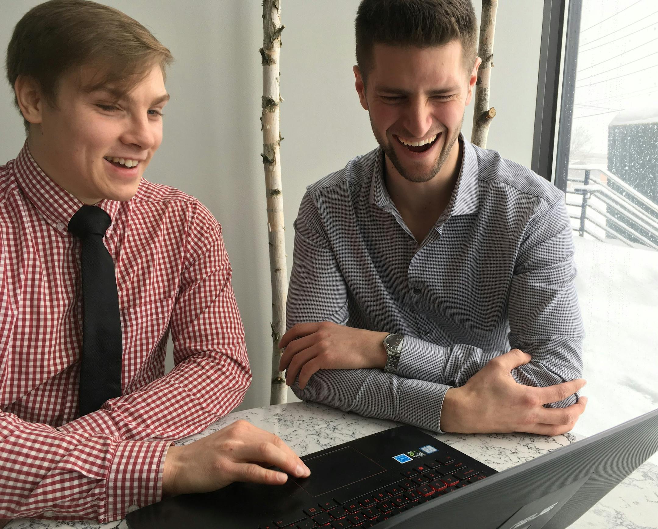 Software developer Tyler Hanson, left, and Dan Nelson, owner of Olio Outdoors are working to create Olio Engine, aweb-based operating system aimed at general contractors. (Staff photo by Jim Buchta)