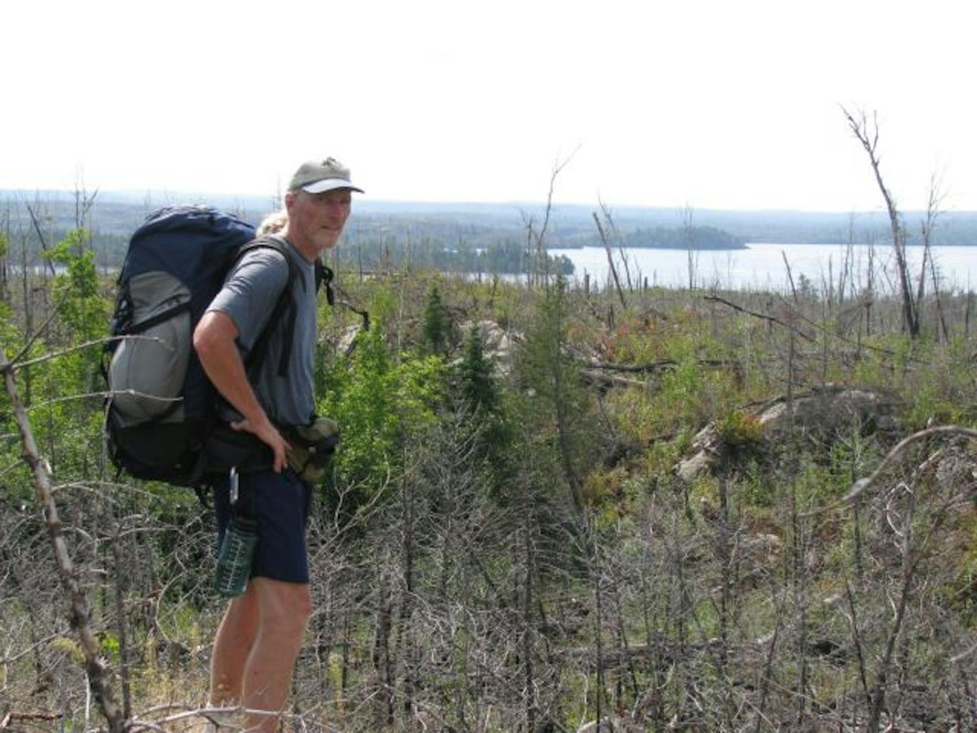 Tim Colburn paused on the top of a ridge to take in a vista of Gabimichigami, Minnesota's deepest lake at 209 feet.