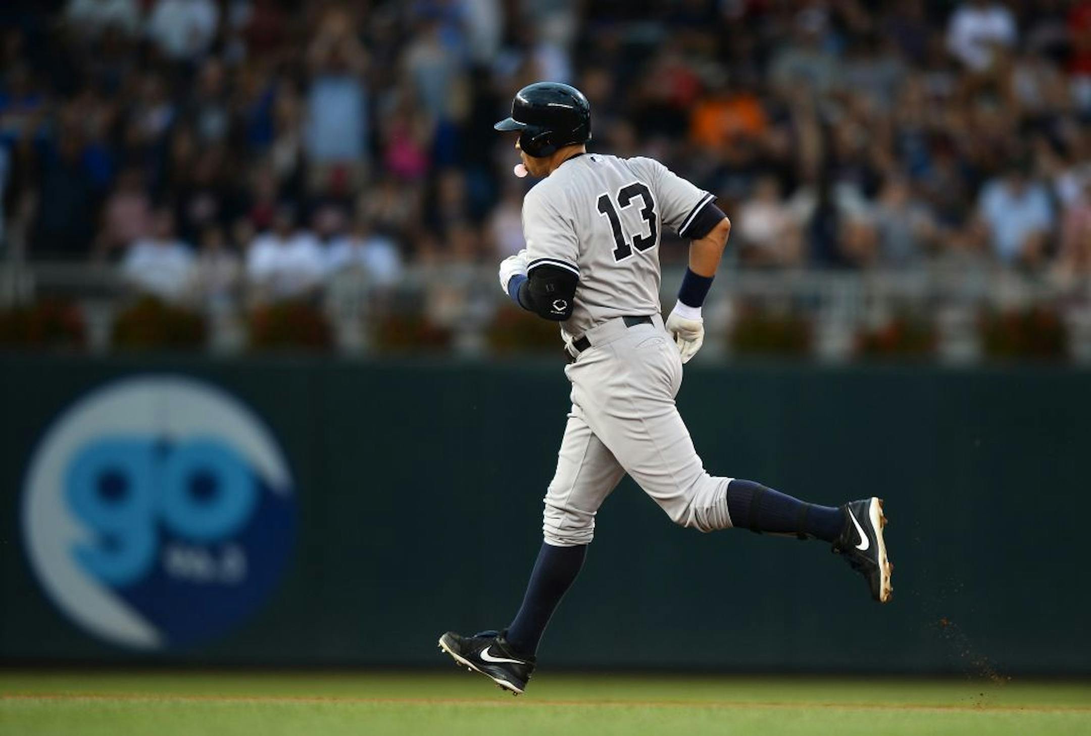 New York Yankees designated hitter Alex Rodriguez (13) blew a bubble while rounding the bases after hitting his second home run of the night in the top of the seventh.