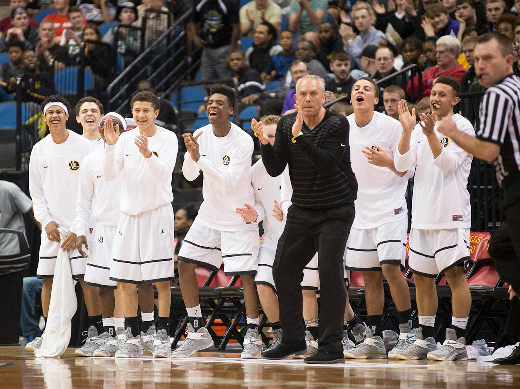 The DeLaSalle bench celebrates after their team scored against St. Paul Johnson in the first half.