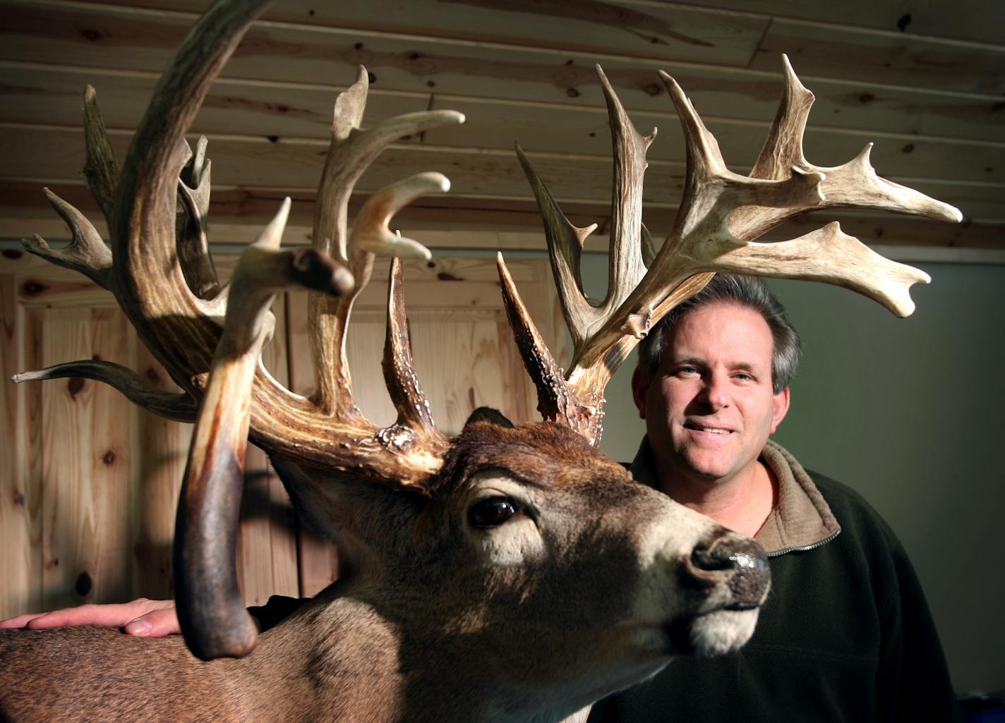 Klaus Lebrecht posed with a reproduction he made of the Minnesota Monarch. The rack, found nearly 20 years ago, is the largest non-typical whitetail rack in the world. He used a mold of the original antlers to reproduce the rack and bought rights to do so from the current owner.