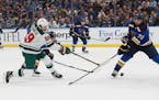 The Wild’s Frederick Gaudreau (89) shot the puck against the Blues’ Justin Faulk (72) during the first period.