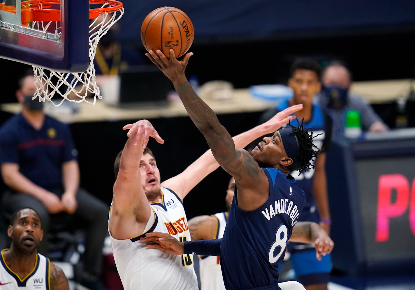 Timberwolves forward Jarred Vanderbilt, right, shoots as Denver center Nikola Jokic defends during the second half TUesday