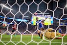 Chelsea forward Bertrand Traore (14) scored off a header on AC Milan goalkeeper Donnarumma Gianluigi in the first half Wednesday night. ] (AARON LAVIN
